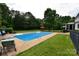 Backyard view of a swimming pool, patio, and grassy lawn, perfect for outdoor enjoyment at 19625 Callaway Hills Ln, Davidson, NC 28036