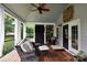 Covered porch with comfortable seating, ceiling fan, and stylish decor for relaxation and enjoyment at 19625 Callaway Hills Ln, Davidson, NC 28036