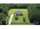 Expansive aerial view of a stately home with lush green lawn, mature trees, and long private driveway at 2018 Whiskery Ct, York, SC 29745