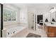 Bright bathroom with soaking tub, tile floors, and adjacent bedroom view at 2018 Whiskery Ct, York, SC 29745