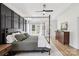 Stylish bedroom featuring a four-poster bed, dark accent wall, tray ceilings, and lots of natural light at 2018 Whiskery Ct, York, SC 29745