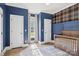 A Bedroom featuring blue walls, a plaid accent wall, white trim, and a wooden crib at 2018 Whiskery Ct, York, SC 29745