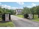 Gated driveway entrance with stone pillars, fencing, and a view of the home at 2018 Whiskery Ct, York, SC 29745