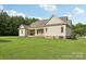 Traditional home with a spacious backyard featuring a covered back patio, lots of natural light and lush grass at 2018 Whiskery Ct, York, SC 29745