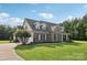 A beautiful home featuring a stone and siding exterior, with a manicured lawn and blue skies at 2018 Whiskery Ct, York, SC 29745