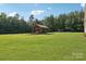 Spacious backyard gazebo with wood construction, seating and an adjacent ' playset at 2018 Whiskery Ct, York, SC 29745