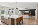 Modern kitchen island with seating, pendant lighting, and open view to the stylish living room at 2018 Whiskery Ct, York, SC 29745