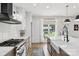 Bright kitchen with white subway tile, stainless steel range, and views to the home's well manicured backyard at 2018 Whiskery Ct, York, SC 29745