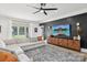 Bright living room featuring a large sectional sofa, modern entertainment center, and stylish decor at 2018 Whiskery Ct, York, SC 29745