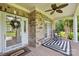 Inviting front porch with decorative wreath, modern rug, and comfortable rocking chair at 2018 Whiskery Ct, York, SC 29745