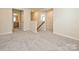 Spacious hallway upstairs with neutral walls and carpet leading to other rooms in the home at 213 J.P. Dr, Albemarle, NC 28001