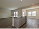 Open concept kitchen featuring gray cabinets, an island with a sink, and modern stainless steel appliances at 213 J.P. Dr, Albemarle, NC 28001