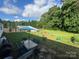 Expansive backyard with a dining set, pool, and lush lawn at 2194 Sterling Ridge Dr, Newton, NC 28658
