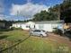 Single story home with light siding, blue shutters, and well-maintained lawn and mature trees at 2194 Sterling Ridge Dr, Newton, NC 28658