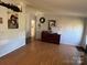 View of a living room with wood flooring, neutral paint, and views to other rooms at 2194 Sterling Ridge Dr, Newton, NC 28658