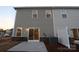 View of the backyard of a home with a concrete patio, sliding glass door and horizontal siding at 222 Harpers Run Ln, Matthews, NC 28104