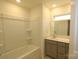Clean bathroom with a shower-tub combo, vanity with cabinet, and neutral decor at 222 Harpers Run Ln, Matthews, NC 28104