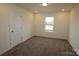 This is a vacant bedroom with carpet flooring and a window at 222 Harpers Run Ln, Matthews, NC 28104
