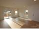 Bright living room with hardwood floors, sliding glass doors, and recessed lighting at 222 Harpers Run Ln, Matthews, NC 28104