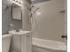 Bathroom with a white vanity, mirror, tiled walls, and a combined tub and shower with fixtures at 24 19Th Nw St, Hickory, NC 28601