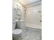 Cozy bathroom with tiled shower and floors, featuring modern sink and vanity with bright vanity lighting at 24 19Th Nw St, Hickory, NC 28601