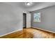 Bedroom with hardwood floors and a window that looks out onto a tree-filled landscape at 24 19Th Nw St, Hickory, NC 28601