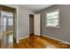 View of a bedroom from the doorway, with hardwood flooring, a window, and access to a closet at 24 19Th Nw St, Hickory, NC 28601