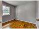 Bedroom featuring hardwood floors, neutral paint, and a bright window offering natural light at 24 19Th Nw St, Hickory, NC 28601