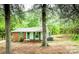 Quaint single-story home with brick and siding facade and lush greenery surrounding the property at 24 19Th Nw St, Hickory, NC 28601