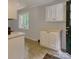 Cozy kitchen features ample white cabinets and drawers, natural lighting, and tile flooring at 24 19Th Nw St, Hickory, NC 28601
