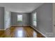 Inviting living room featuring hardwood floors and natural light from two windows at 24 19Th Nw St, Hickory, NC 28601