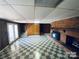 Large basement with checkered floors, brick fireplace, and access to the outside at 2405 Forrestbrook Dr, Kannapolis, NC 28083