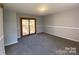 Light-filled bedroom with neutral walls, carpet, and sliding glass doors to deck at 2405 Forrestbrook Dr, Kannapolis, NC 28083