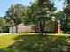 Charming brick home featuring an attached garage, white siding, and lovely landscaping at 2405 Forrestbrook Dr, Kannapolis, NC 28083