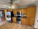Well-lit kitchen featuring stainless steel appliances, tile floors, and wood cabinets at 2405 Forrestbrook Dr, Kannapolis, NC 28083
