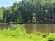 Scenic view of a tranquil lake surrounded by lush greenery and trees at 2405 Forrestbrook Dr, Kannapolis, NC 28083