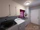 Functional laundry room with washer, dryer, sink, and storage cabinets at 2405 Forrestbrook Dr, Kannapolis, NC 28083