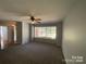 Spacious living room with large window and neutral carpet with a ceiling fan at 2405 Forrestbrook Dr, Kannapolis, NC 28083