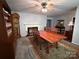 Open-concept living room featuring a fireplace, dining table, and abundant natural light at 2405 Forrestbrook Dr, Kannapolis, NC 28083