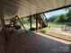 Covered patio area with brick flooring, stairs, and a swing at 2405 Forrestbrook Dr, Kannapolis, NC 28083