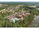 Stunning aerial view of community clubhouse, pool, lake and surrounding neighborhood offering picturesque scenery at 26444 Sandpiper Ct, Fort Mill, SC 29707
