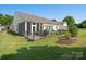 Green backyard features a fenced patio and sunroom, ideal for outdoor living and entertaining at 26444 Sandpiper Ct, Fort Mill, SC 29707