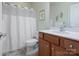 Traditional bathroom features a shower-tub combo and a wood vanity with ample storage at 26444 Sandpiper Ct, Fort Mill, SC 29707