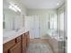 Bathroom featuring double sinks, walk in shower and soaking tub at 26444 Sandpiper Ct, Fort Mill, SC 29707