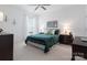 Well-lit bedroom features a ceiling fan, plush carpeting, and dark wood furniture at 26444 Sandpiper Ct, Fort Mill, SC 29707