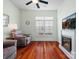 Cozy living room featuring fireplace, window with shutters, and hardwood flooring at 26444 Sandpiper Ct, Fort Mill, SC 29707