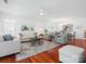 Spacious living room with hardwood floors, ceiling fan, and view to the dining area at 26444 Sandpiper Ct, Fort Mill, SC 29707