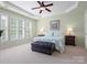 Inviting main bedroom with large windows, tray ceiling, and plush decor at 26444 Sandpiper Ct, Fort Mill, SC 29707