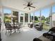 Bright sunroom features large windows, tile flooring, and comfortable seating and dining area at 26444 Sandpiper Ct, Fort Mill, SC 29707
