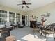 Inviting sunroom features a fireplace, ceiling fan, and comfortable seating and dining area at 26444 Sandpiper Ct, Fort Mill, SC 29707